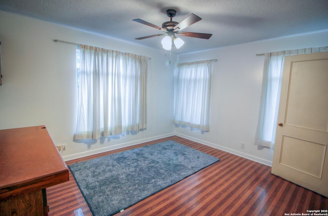 interior space with ceiling fan, a wealth of natural light, and a textured ceiling