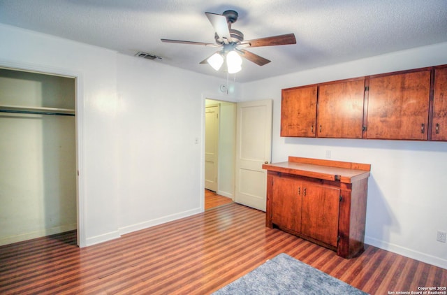 interior space with ceiling fan, light hardwood / wood-style flooring, a closet, and a textured ceiling