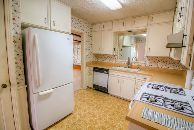 kitchen featuring white appliances, a textured ceiling, white cabinetry, and sink