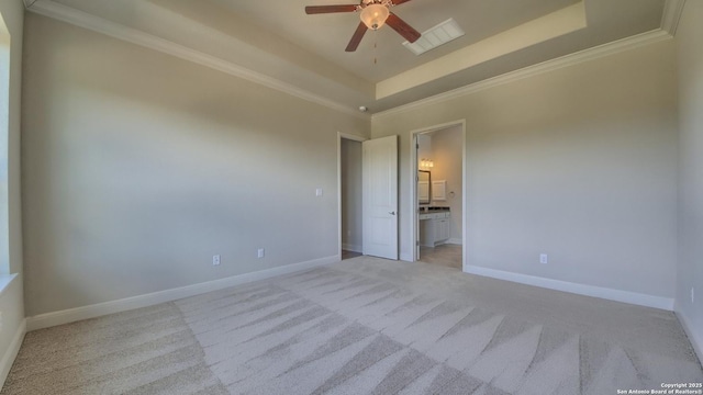 carpeted empty room with a tray ceiling, ceiling fan, and ornamental molding