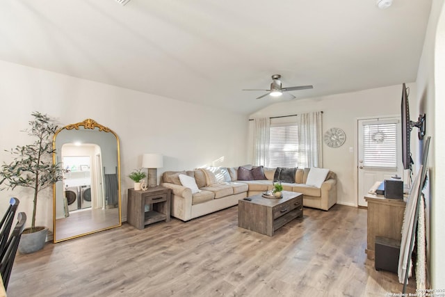 living room featuring ceiling fan, light wood-type flooring, separate washer and dryer, and lofted ceiling