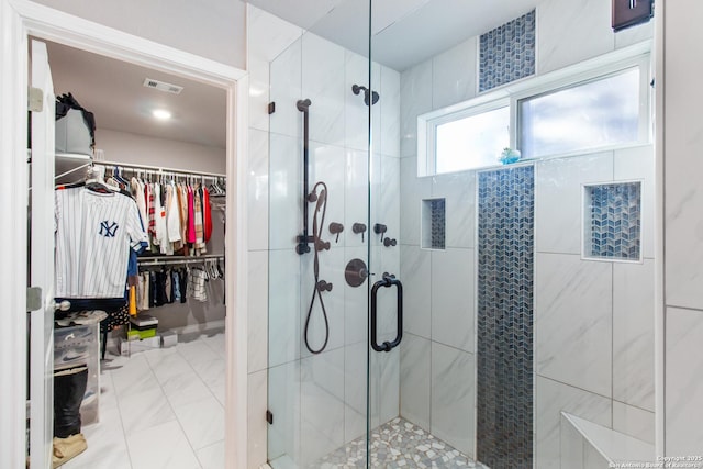 bathroom featuring a shower with door