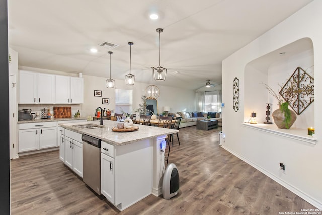 kitchen featuring white cabinetry, sink, ceiling fan, stainless steel dishwasher, and an island with sink