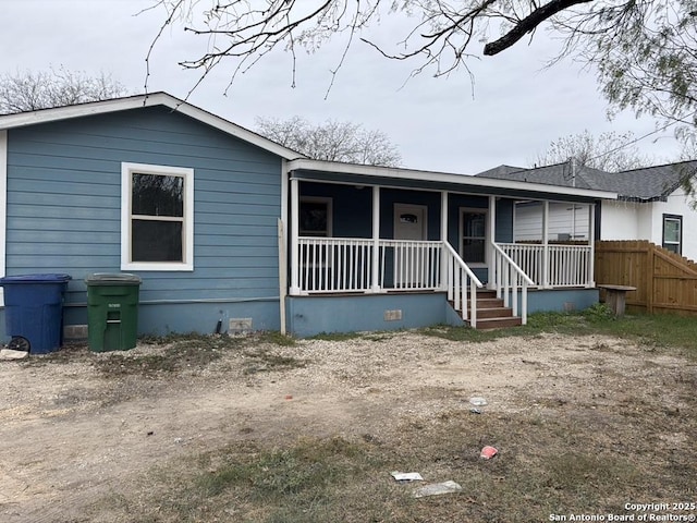 back of house featuring a porch