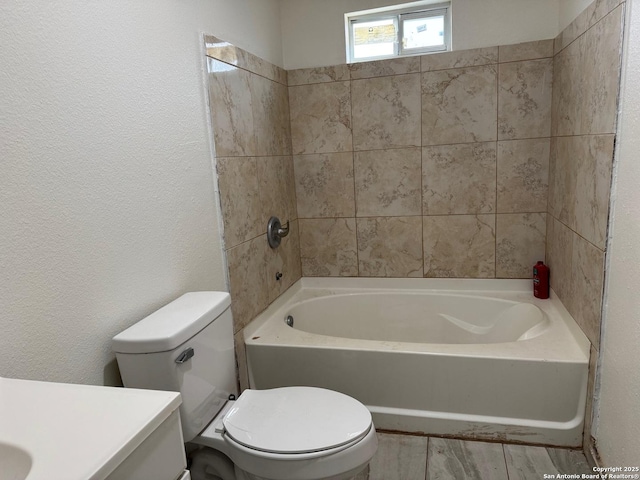 full bathroom featuring vanity, toilet, and tiled shower / bath