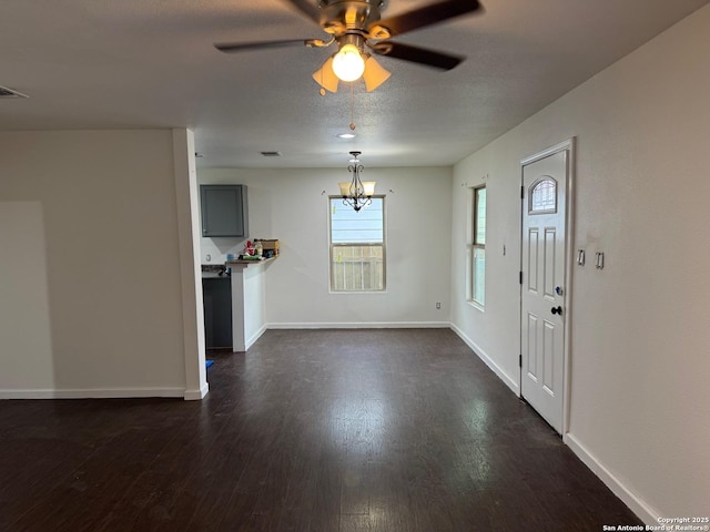 foyer entrance with a textured ceiling, ceiling fan with notable chandelier, and dark hardwood / wood-style floors