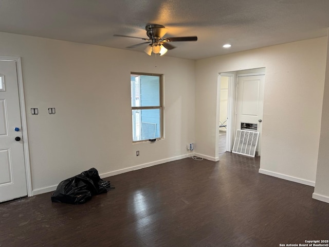 unfurnished room with ceiling fan and dark wood-type flooring