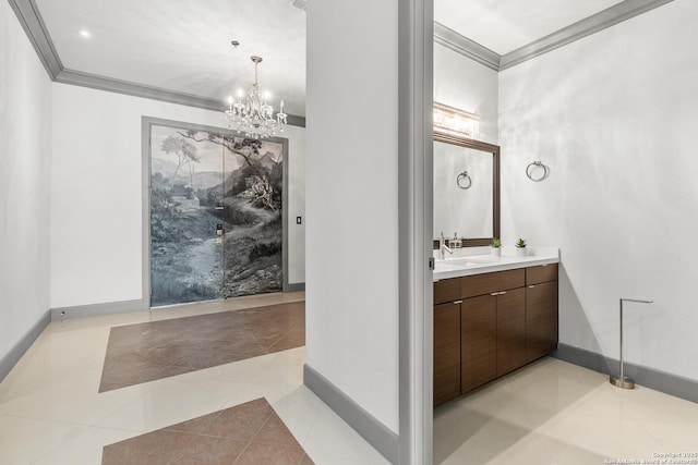 bathroom with tile patterned flooring, vanity, an inviting chandelier, and ornamental molding