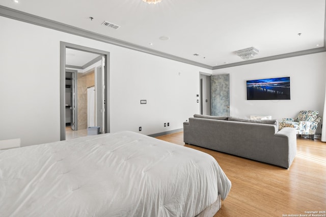 bedroom featuring crown molding and light hardwood / wood-style floors