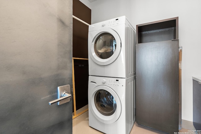 laundry room featuring stacked washer and clothes dryer