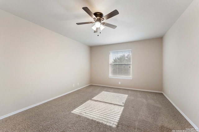 carpeted spare room with ceiling fan