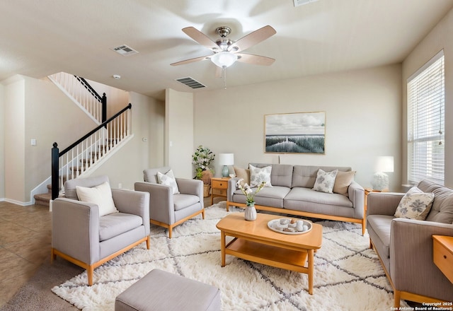 living room with ceiling fan and light tile patterned flooring