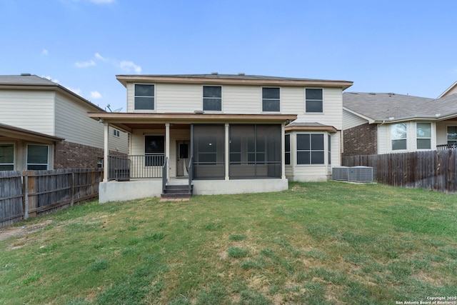 rear view of property with a yard