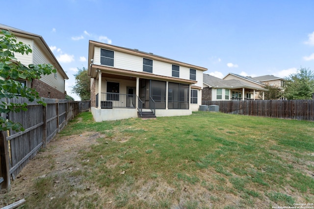 back of property with a yard and central AC unit