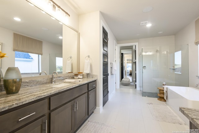 bathroom with vanity and separate shower and tub