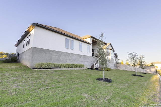 view of side of home featuring a yard