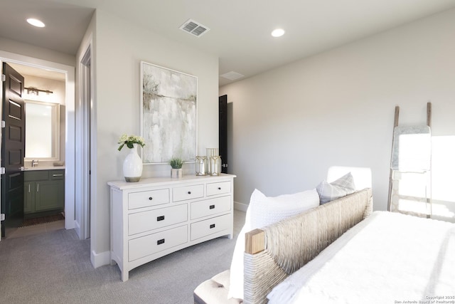 carpeted bedroom featuring connected bathroom