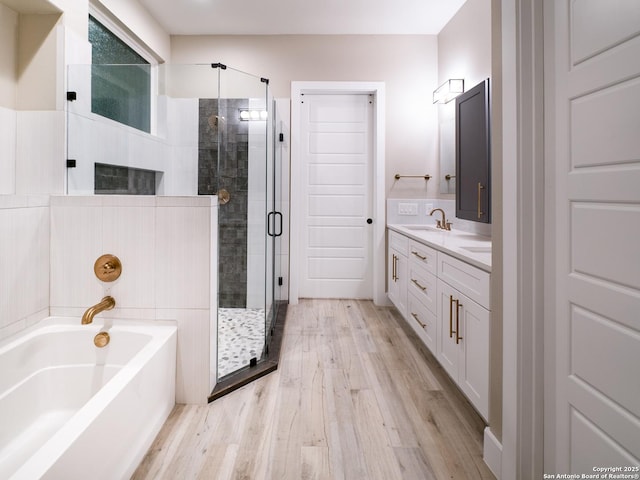 bathroom with vanity, wood-type flooring, and plus walk in shower