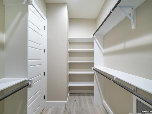 walk in closet featuring light hardwood / wood-style flooring