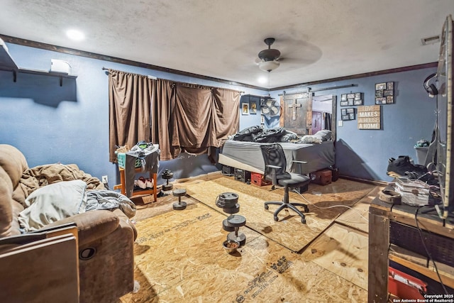 bedroom featuring ceiling fan, crown molding, and a textured ceiling