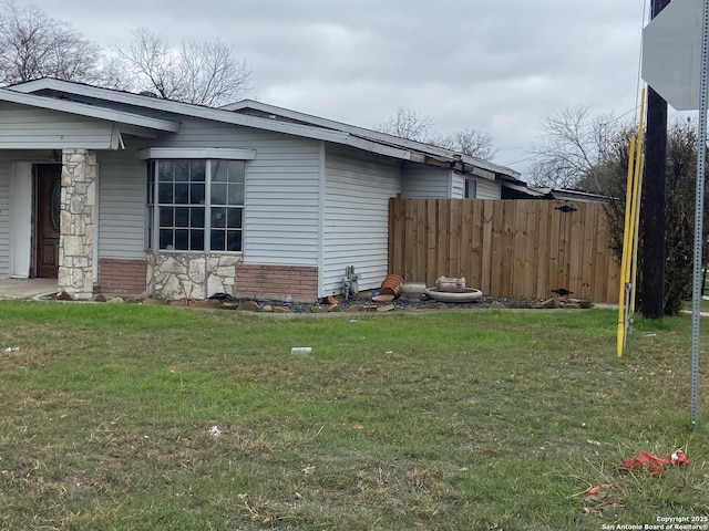 view of property exterior with a yard