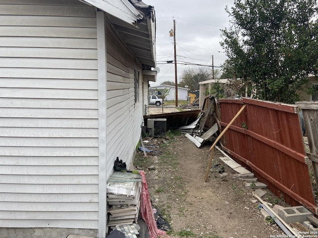 view of side of home featuring central AC unit