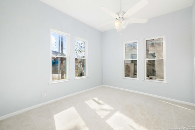 carpeted empty room featuring ceiling fan