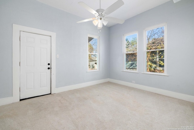 unfurnished room featuring light colored carpet and ceiling fan