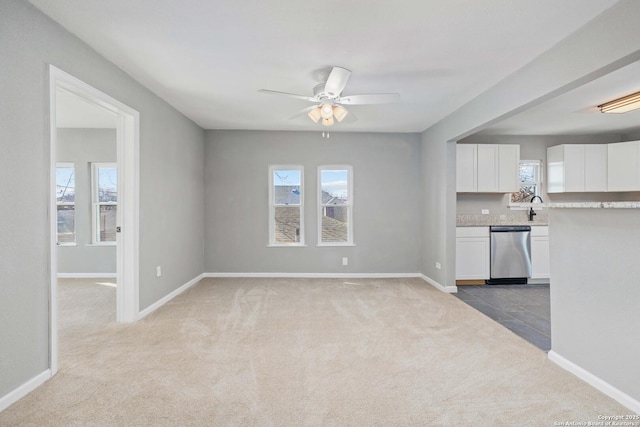 interior space featuring ceiling fan, sink, and light colored carpet