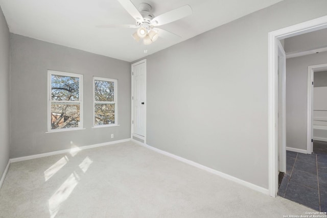 carpeted empty room with ceiling fan