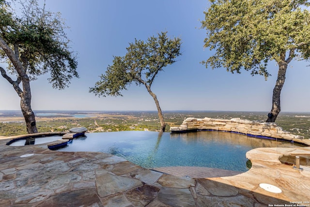 view of pool featuring a water view