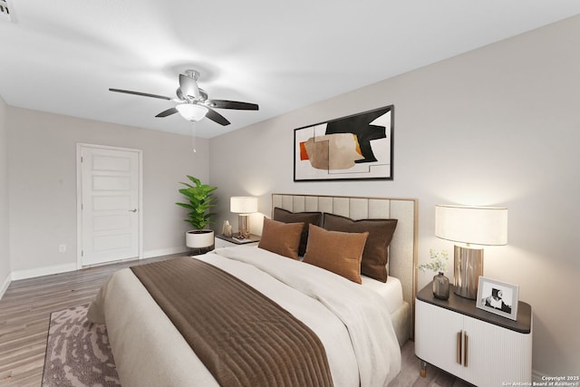 bedroom featuring dark hardwood / wood-style floors and ceiling fan