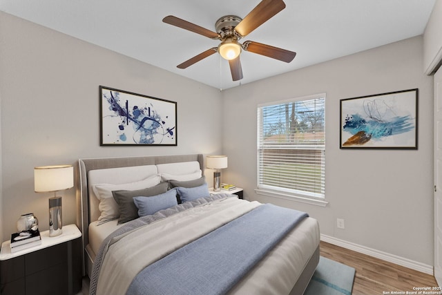 bedroom with hardwood / wood-style floors and ceiling fan