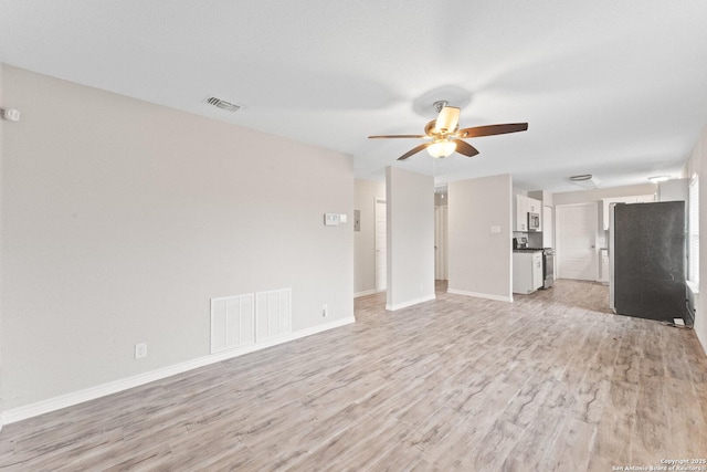 unfurnished living room featuring ceiling fan and light wood-type flooring