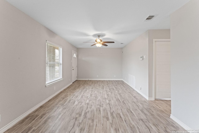 empty room with light hardwood / wood-style flooring and ceiling fan