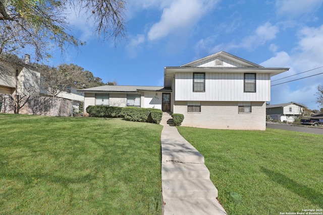 split level home with a front lawn