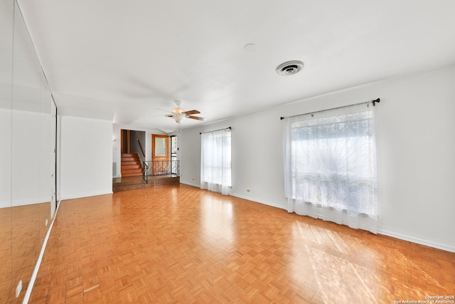 unfurnished living room featuring ceiling fan and light parquet flooring