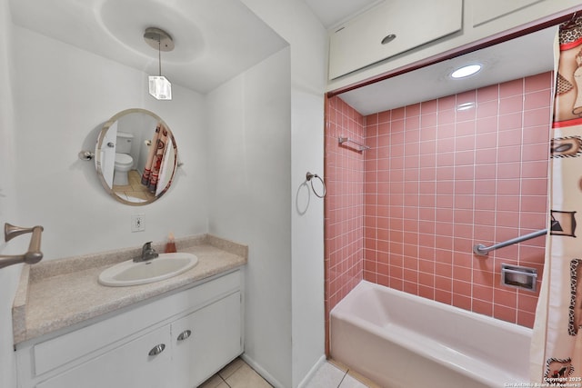 bathroom featuring tile patterned flooring, shower / bath combo, and vanity