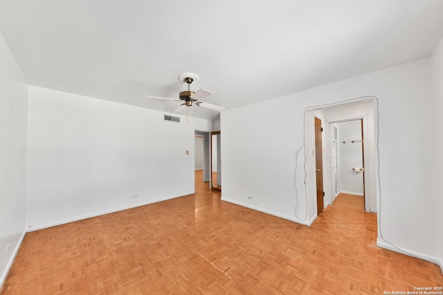 empty room featuring ceiling fan and light parquet floors