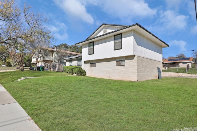 view of side of home featuring a yard