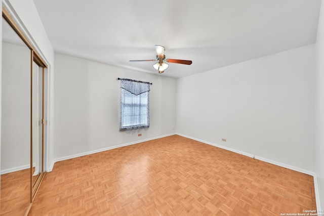 unfurnished bedroom with light parquet flooring and ceiling fan