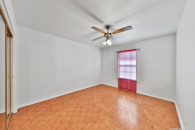 spare room featuring light parquet flooring and ceiling fan