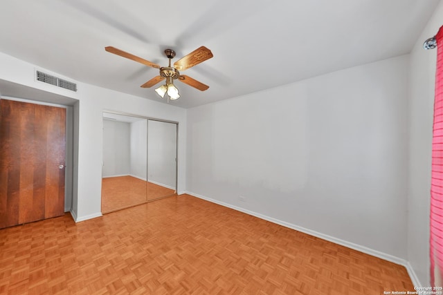 unfurnished bedroom featuring light parquet flooring and ceiling fan