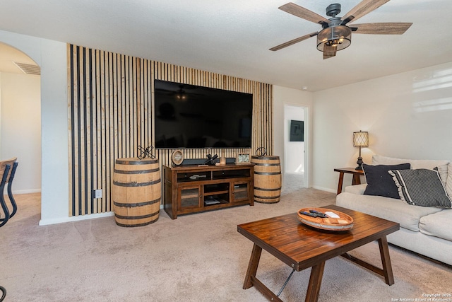 living room with ceiling fan and light colored carpet