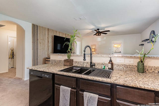 kitchen with dark brown cabinetry, ceiling fan, dishwasher, sink, and light colored carpet