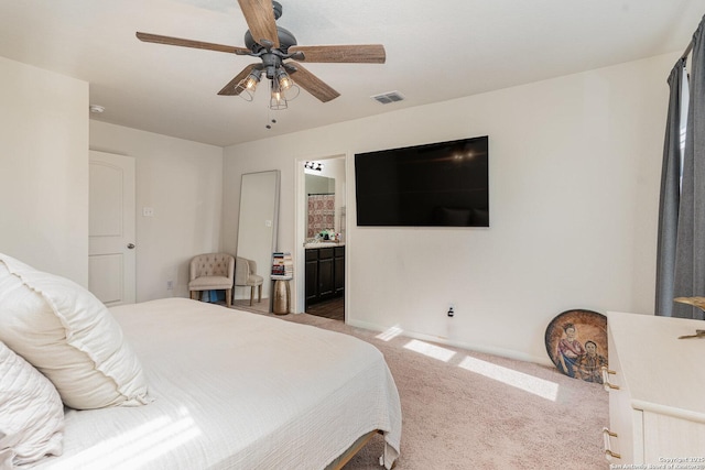 bedroom featuring carpet flooring, ceiling fan, and ensuite bathroom