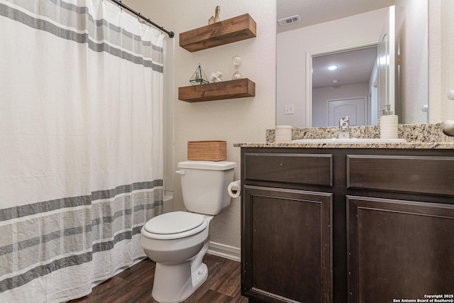 bathroom with hardwood / wood-style floors, vanity, and toilet