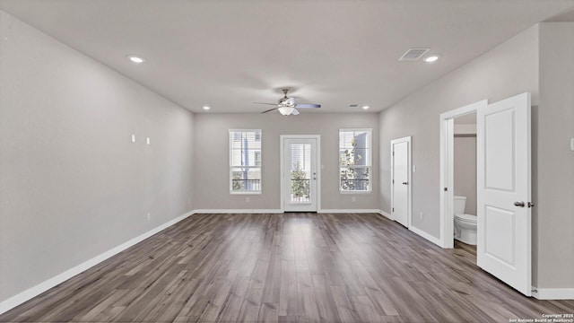 spare room with ceiling fan and hardwood / wood-style flooring