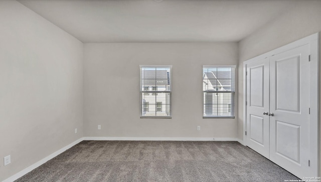 unfurnished room featuring light colored carpet