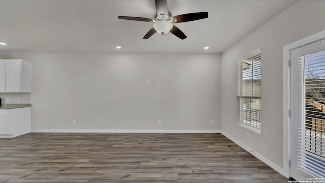 unfurnished room with ceiling fan and light hardwood / wood-style floors